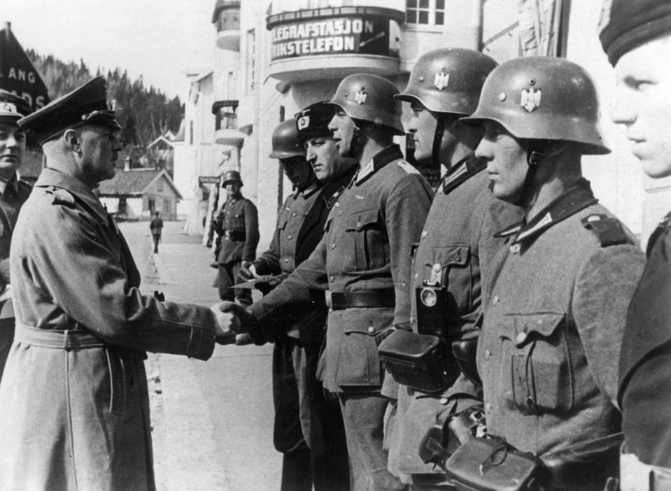 A German general decorating with the Iron Cross some soldiers of the Expeditionary Force and two soldiers of the SS, in Denmark, April 1940. <em>Photo by Mondadori via Getty Images</em>