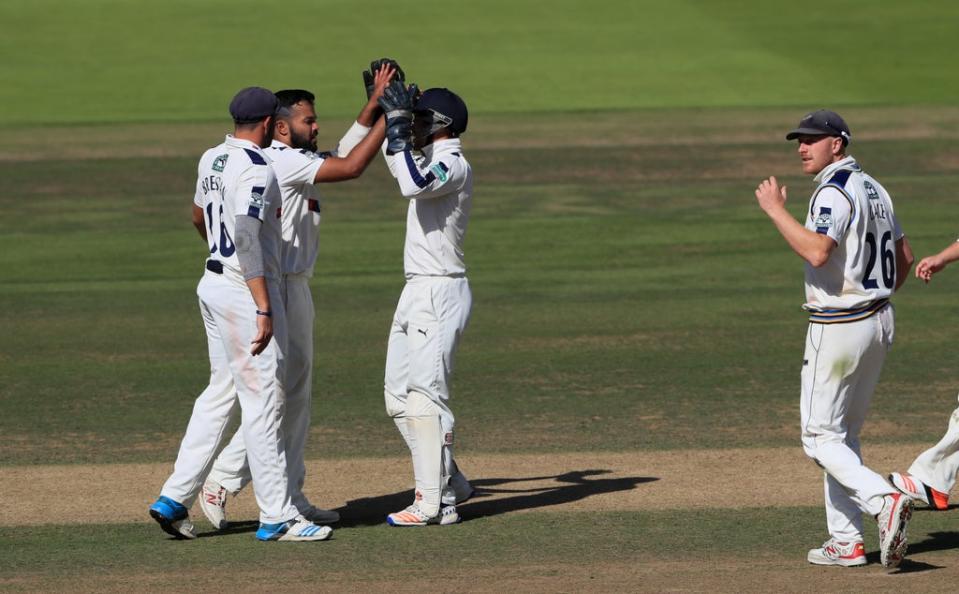 Azeem Rafiq, second left, celebrates taking the wicket of Middlesex’s Nick Gubbins during his playing days with the club (John Walton/PA) (PA Archive)