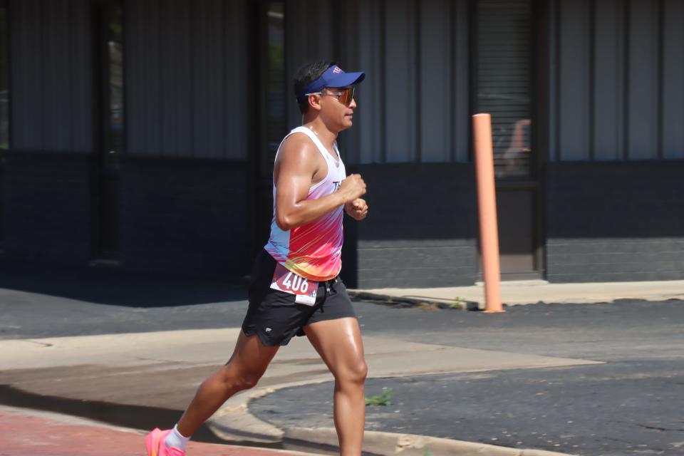 Ricardo Aguilar crosses the finish line first Saturday morning in the Fitness @ KT Black 5K/1K Run/Walk, which was part of the Texas Route 66 Festival and benefitting the Hope Lives Here organization.