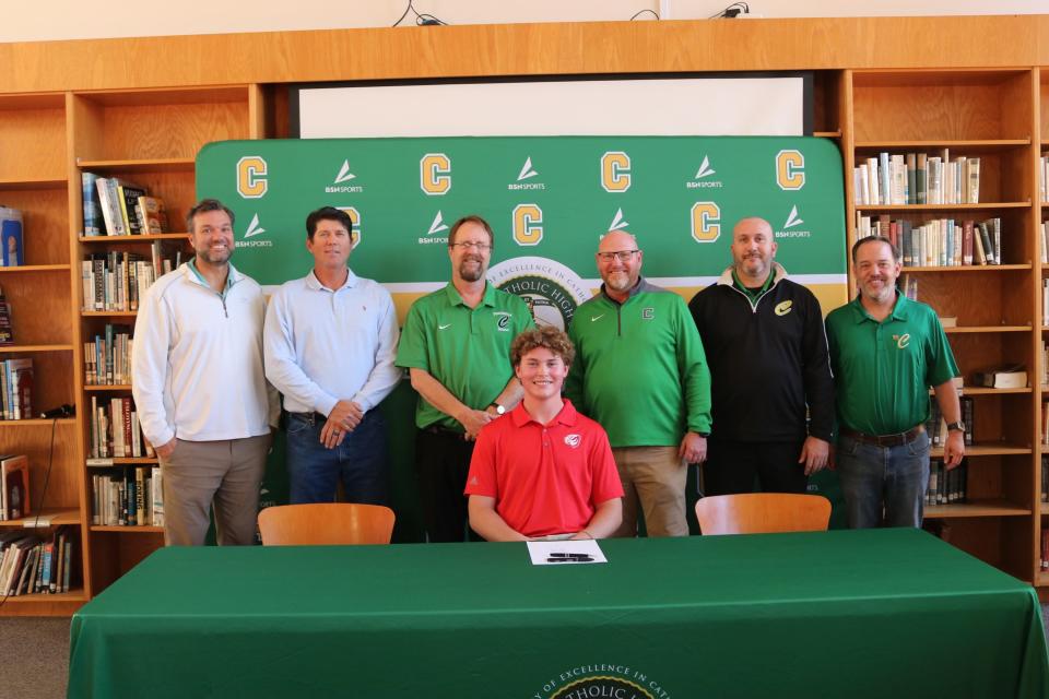 Pensacola Catholic's Jackson Kohr (seated) poses for photos with Crusaders baseball coaches after signing his letter of intent to play baseball collegiately for the University of West Alabama on Wednesday, Nov. 8, 2023 from Pensacola Catholic High School media center.