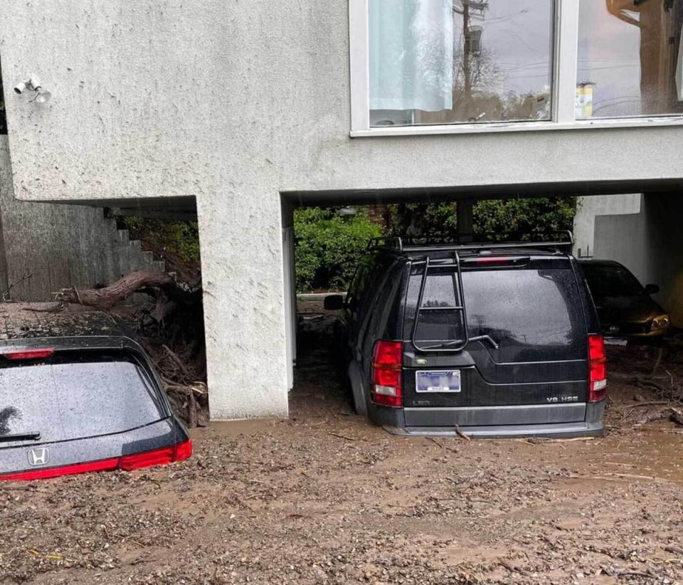 Cars submerged in mud up to the windshields (Mike Bedigan / The Independent)