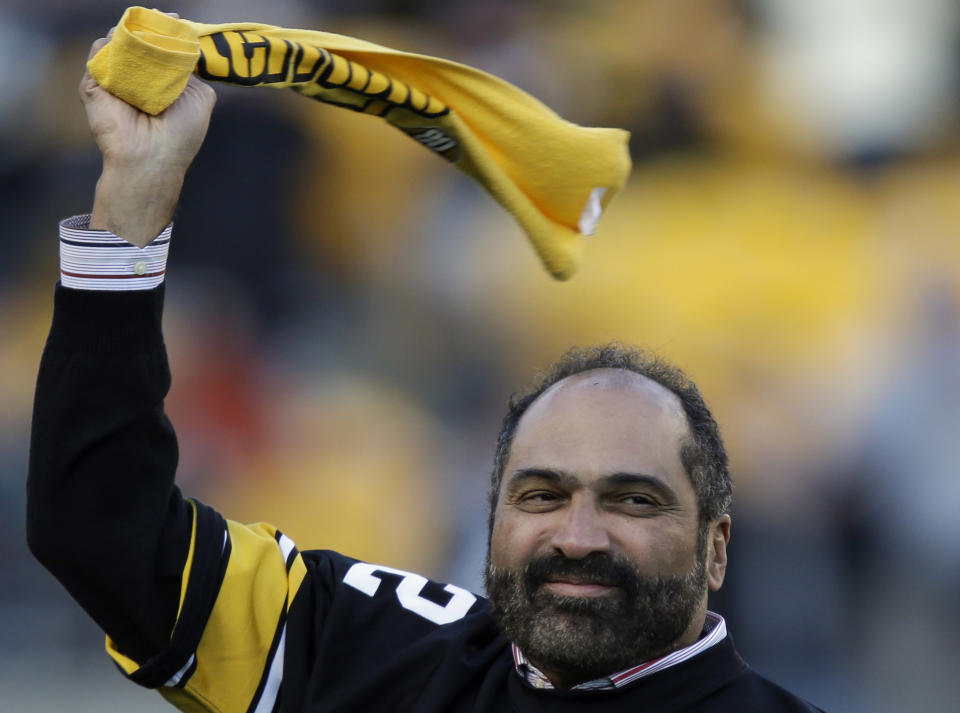 FILE - Pittsburgh Steelers Hall of Fame running back Franco Harris twirls a Terrible Towel during a ceremony commemorating the 40th anniversary of his "Immaculate Reception" catch in the 1972 playoff game against the Oakland Raiders, during the halftime of an NFL football game between the Steelers and the Cincinnati Bengals in Pittsburgh, Sunday, Dec. 23, 2012. Franco Harris, the Hall of Fame running back whose heads-up thinking authored “The Immaculate Reception,” considered the most iconic play in NFL history, died Wednesday, Dec. 21, 2022. He was 72. (AP Photo/Gene J. Puskar, File)