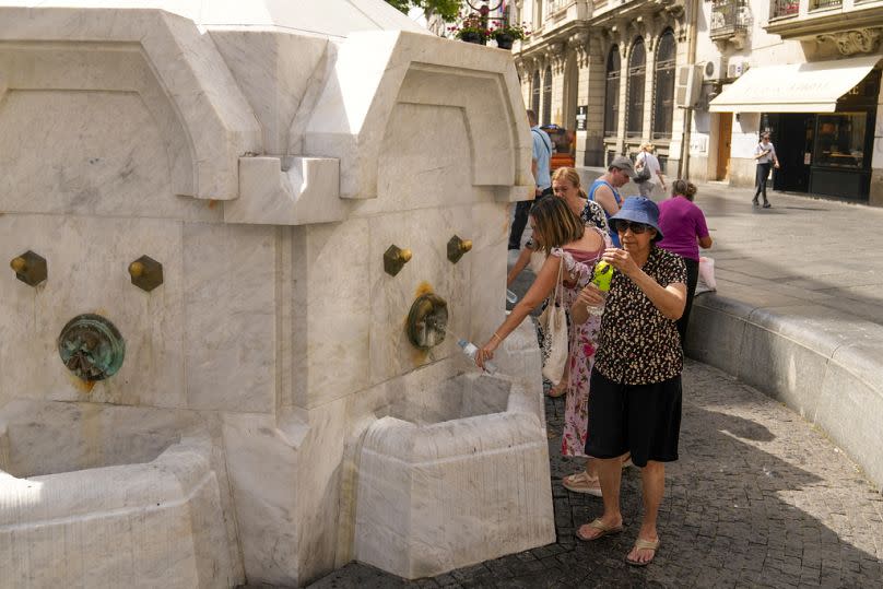 Extreme heat hits Europe: residents and tourists fill up their water bottles from a public fountain in Belgrade, Serbia