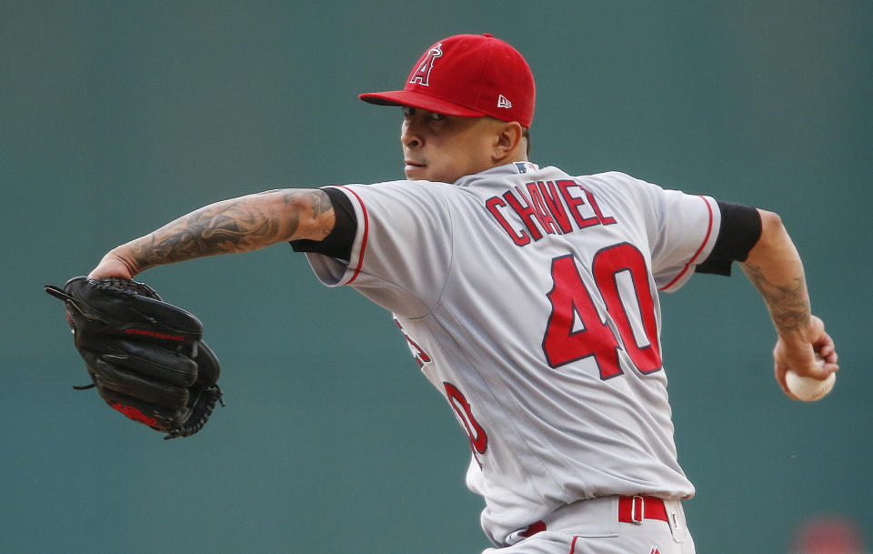 FILE - Los Angeles Angels starting pitcher Jesse Chavez winds up during the first inning of the team's baseball game against the Cleveland Indians in Cleveland, in this Tuesday, July 25, 2017, file photo. Veteran right-hander Jesse Chavez has re-signed with the Los Angeles Angels on a minor league deal. Chavez will join the Angels’ spring training camp in Tempe, Arizona, after he clears their intake protocols. (AP Photo/Ron Schwane, File)