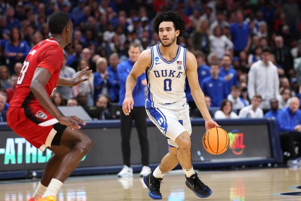 Duke Blue Devils guard Jared McCain (0) controls the ball against North Carolina State Wolfpack forward Mohamed Diarra (23) in the first half in the finals of the South Regional of the 2024 NCAA Tournament at American Airlines Center.