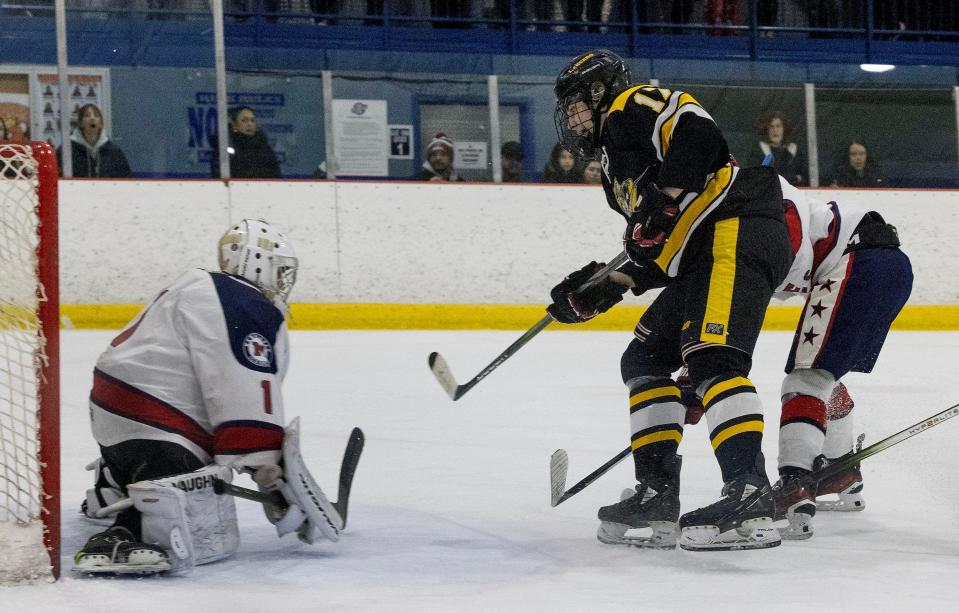 Vianney’s Blaise Lucky shoots against Manalapan's Christian Esposito. Saint John Vianney Ice Hockey vs Manalapan on January 5, 2024 in Wall, NJ.