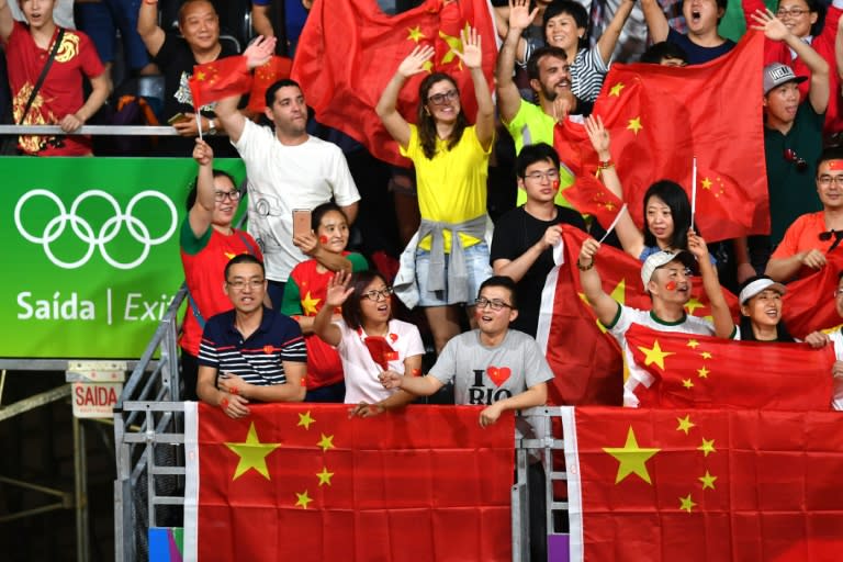 China supporters watch as Denmark's Viktor Axelsen plays Lin Dan in the badminton men's singles bronze medal match in on August 20, 2016