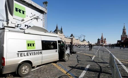 FILE PHOTO: Vehicles of Russian state-controlled broadcaster Russia Today are seen at Red Square in central Moscow