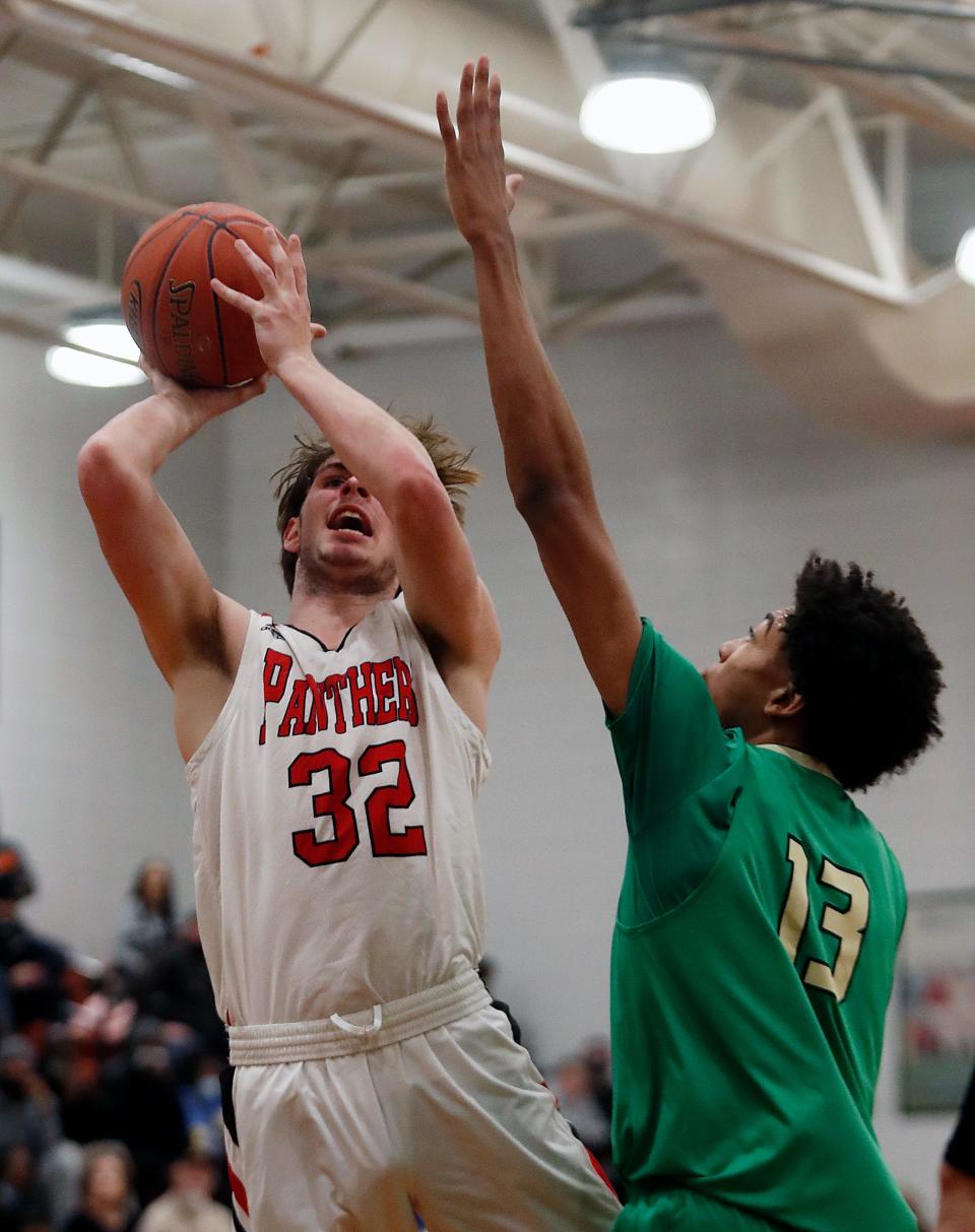 Pleasure Ridge Park’s Keith Robinson gets the shot against Western’s Jayden Miles. Feb. 18, 2022