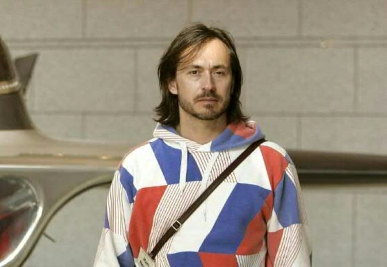 Australian designer Marc Newson poses in front of one of his designs during a press preview in Tokyo in April 2006