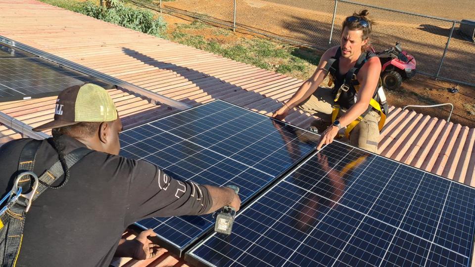 Fitting a solar panel in the NT.