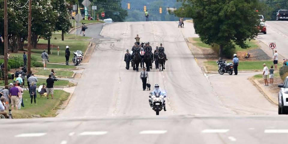 Slain Wake County Sheriffs Deputy Ned Byrds K9 partner, Sasha, leads the N.C. State Highway Patrols Caisson Unit during a procession for Deputy Byrd before his funeral at Providence Baptist Church in Raleigh, N.C., Friday, August 19, 2022.