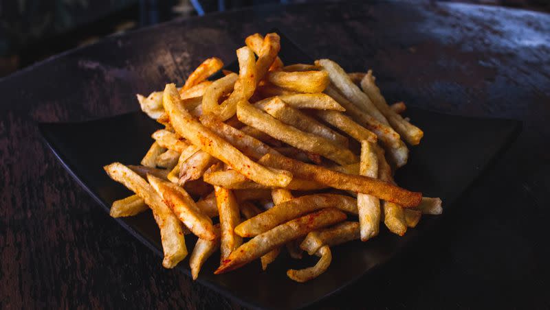French fries on a plate on a table.