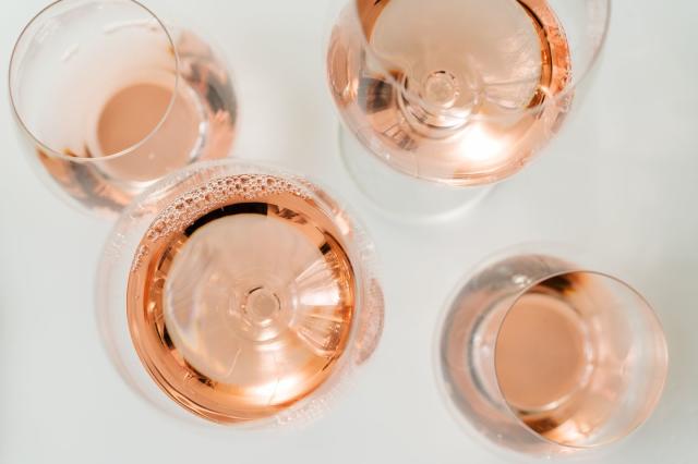 glasses of rose wine on white background