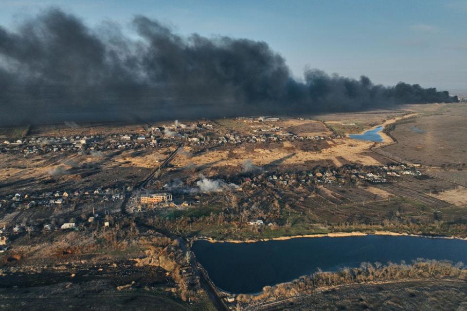 A general view of smoke rising from the Avdiivka Coke and Chemical Plant behind the village of Lastochkino, which is under fire from MLRS 