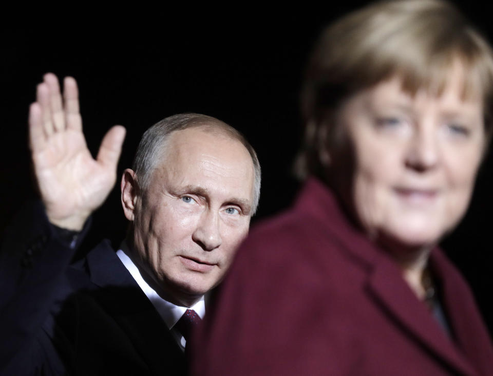 FILE - President of Russia Vladimir Putin waves after he meets this time German Chancellor Angela Merkel for a summit with the leaders of Russia, Ukraine and France at the chancellery in Berlin, Oct. 19, 2016. Germany's refusal to join other NATO members in supplying Ukraine with weapons has frustrated allies and prompted some to question Berlin's resolve in standing up to Russia. (AP Photo/Markus Schreiber, File)