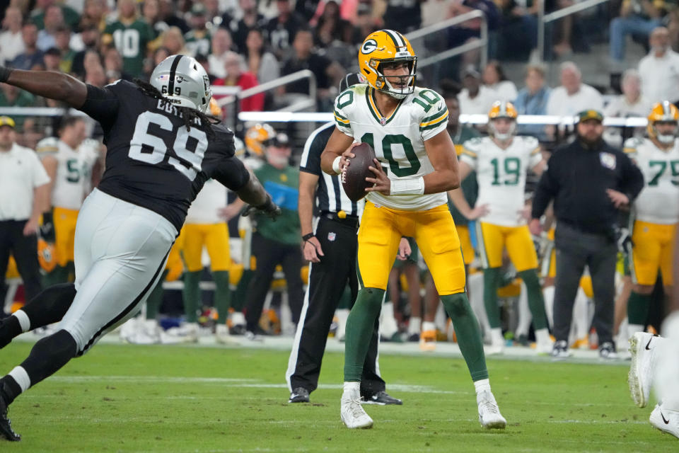 Oct 9, 2023; Paradise, Nevada, USA; Green Bay Packers quarterback Jordan Love (10) is pressured by Las Vegas Raiders defensive tackle Adam Butler (69) in the first half at Allegiant Stadium. Mandatory Credit: Kirby Lee-USA TODAY Sports