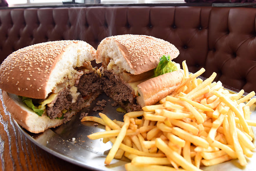 The gut-busting burger, which contains more than 42,000 kilojoules, is made up of a beef patty that weighs more than a kilogram, eight rashers of bacon, eight onion rings, melted cheddar cheese, fries and coleslaw - among other things. Currently being dished up at quiet canal-side pub, The Farmer’s Arms, in the UK.