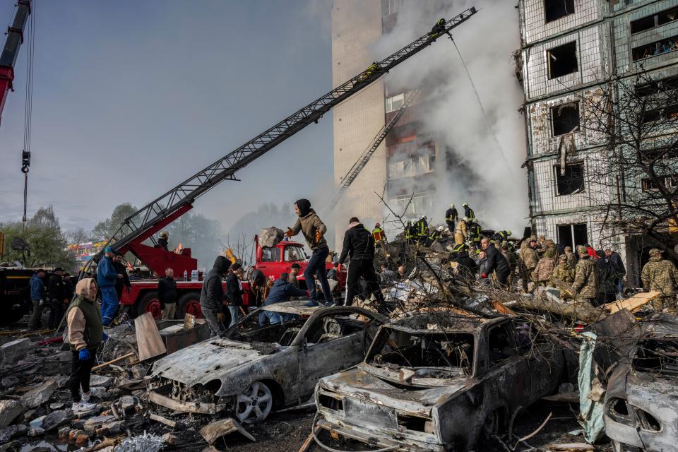Following a Russian attack, first responders remove rubble at a residential building in Uman, central Ukraine, Friday, April 28, 2023.