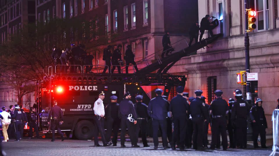 NYPD officers in riot gear break into a building at Columbia University, where pro-Palestinian students are barricaded inside a building and have set up an encampment, in New York City on April 30, 2024. - Kena Betancur/AFP/Getty Images