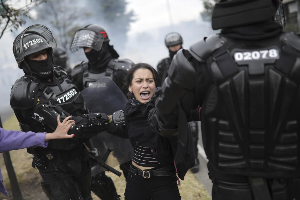 Police detain a protester in Bogota, Colombia, Tuesday, Jan. 21, 2020. Student and labor groups called for new protests as they hope to reignite demonstrations against President Ivan Duque that brought thousands to the streets late last year with a wide range of grievances with his conservative government. (AP Photo/Ivan Valencia)