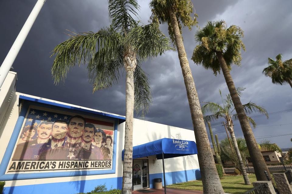 This Tuesday, July 30, 2019 photo shows the exterior of American Legion Post 41 in Phoenix. The post was established by Mexican Americans after World War II when segregation once ruled the U.S. Southwest as well as the Deep South. It now serves menudo Sunday mornings at the building painted with a mural of service members under the words: “America’s Hispanic Heroes.” (AP Photo/Ross D. Franklin)