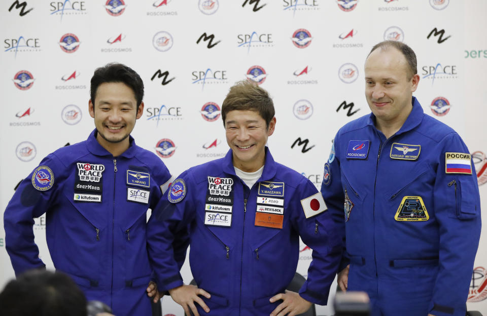 Roscosmos cosmonaut Alexander Misurkin, right, space flight participants Yusaku Maezawa, center, and Yozo Hirano attend a news conference ahead of the expedition to the International Space Station at the Gagarin Cosmonauts' Training Center in Star City outside Moscow, Russia, Thursday, Oct. 14, 2021. A Japanese fashion tycoon who's booked a SpaceX ride to the moon is going to try out the International Space Station first. Yusaku Maezawa announced that he's bought two seats on a Russian Soyuz capsule. He'll blast off in December on the 12-day mission with his production assistant and a professional cosmonaut. (Shamil Zhumatov/Pool Photo via AP)