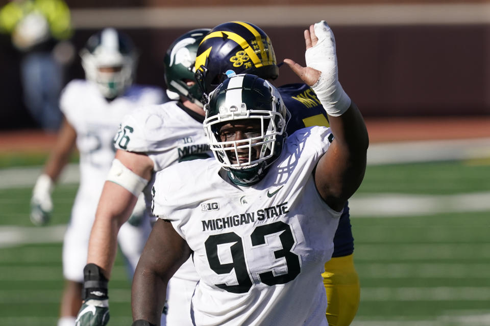 Michigan State defensive tackle Naquan Jones (93) reacts after sacking Michigan quarterback Joe Milton during the second half of an NCAA college football game, Saturday, Oct. 31, 2020, in Ann Arbor, Mich. (AP Photo/Carlos Osorio)