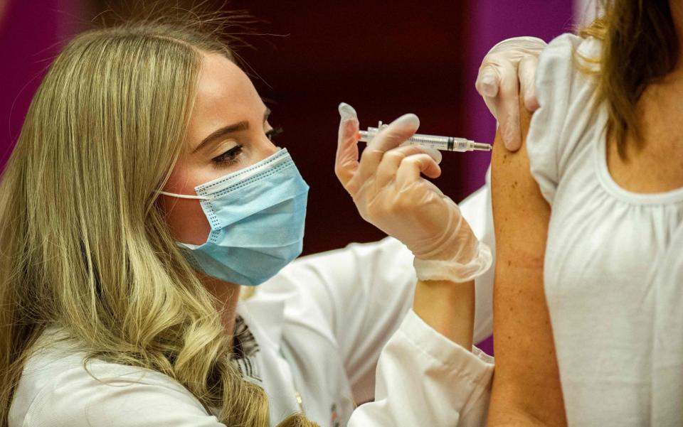 Pharmacist Madeline Acquilano inoculates a teacher with the Johnson & Johnson Covid-19 Vaccine - JOSEPH PREZIOSO/AFP