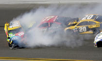 <p>Erik Jones (77) and Matt Kenseth (20) collide with Kyle Busch (18) during the NASCAR Daytona 500 auto race at Daytona International Speedway in Daytona Beach, Fla., Sunday, Feb. 26, 2017. (Photo: Darryl Graham/AP) </p>