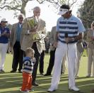 Bubba Watson is joined by his son Caleb at the ceremony after his victory in the Northern Trust Open golf tournament at Riviera Country Club in the Pacific Palisades area of Los Angeles, Sunday, Feb. 16, 2014. Watson carded a 15-under-par 269, two strokes ahead of the second-place finisher. (AP Photo/Reed Saxon)