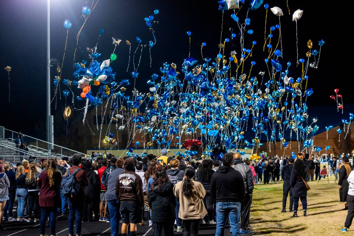 Mourners release balloons at the conclusion of a vigil Wednesday, Jan. 24, 2024 on the track of Charles T. Tucker Stadium at Smithfield-Selma High School in Johnston County. Five Smithfield-Selma students were memorialized including four boys who died in a car wreck early Monday morning.