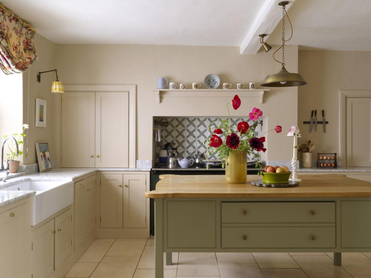 mary graham's pebble dash millhouse on an exposed slope above the river ure\, set in traditional farmland in the north of england a custom oaktopped island, leafy italian tiles, and a subtle taupe scheme bring serene balance to the kitchen