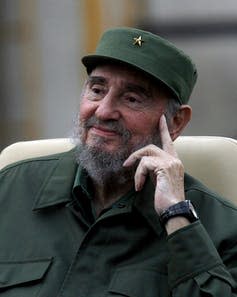 Picture of an aged Fidel Castro in olive army garb, smiling slightly