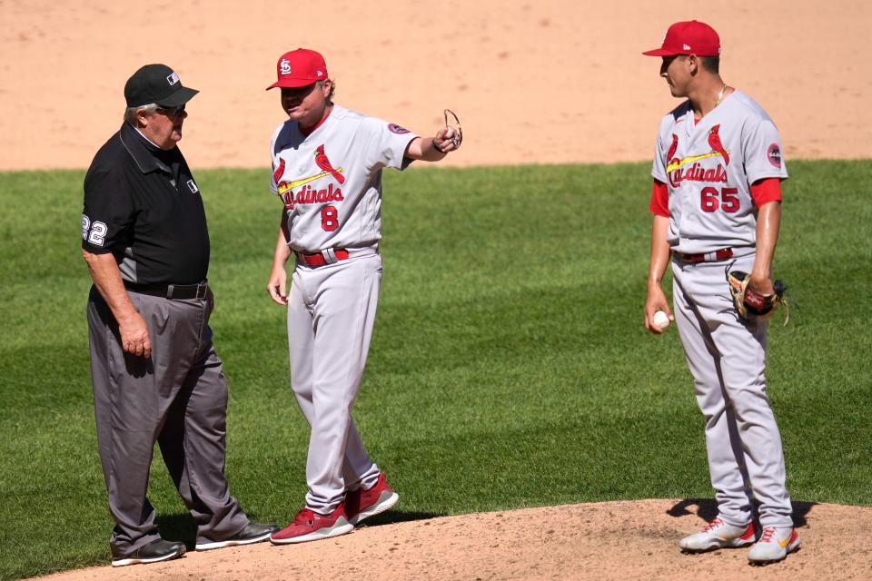 Cardinals manager Mike Shildt argues with umpires after they ordered Giovanny Gallegos to switch caps because there was sunscreen on the bill during a game in May.