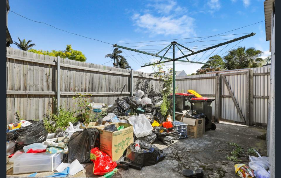 The rear courtyard of the Newtown property with rubbish piled up.