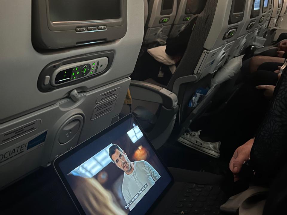 A view of my row of seats with a laptop playing a movie.