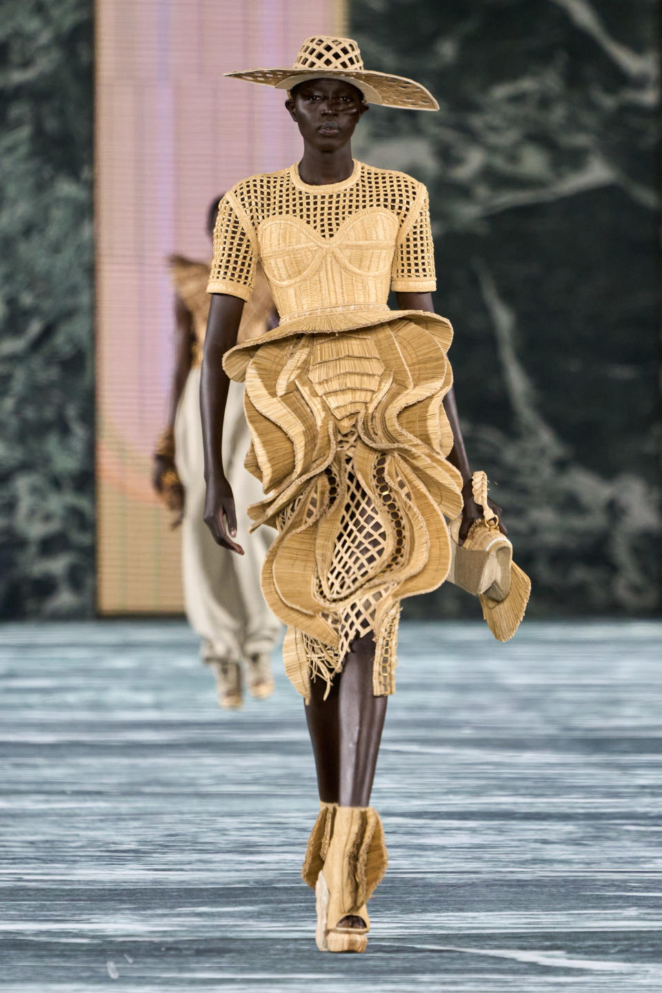 An organic straw look from Balmain spring summer ’23, which featured hundreds of looks on the runway. - Credit: Getty