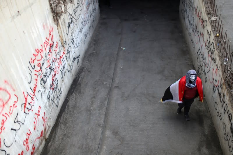 An Iraqi demonstrator walks inside the high-rise building, called by Iraqi the Turkish Restaurant Building, during anti-government protests in Baghdad