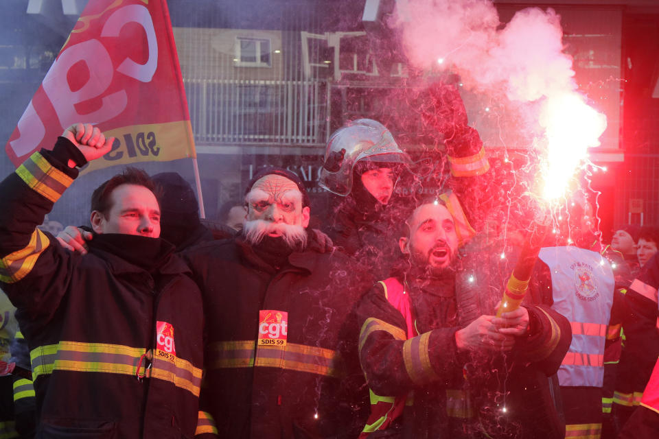 Firefighters demonstrate against pension changes, Thursday, Jan. 19, 2023 in Lille, northern France. Workers in many French cities took to the streets Thursday to reject proposed pension changes that would push back the retirement age, amid a day of nationwide strikes and protests seen as a major test for Emmanuel Macron and his presidency. (AP Photo/Michel Spingler)