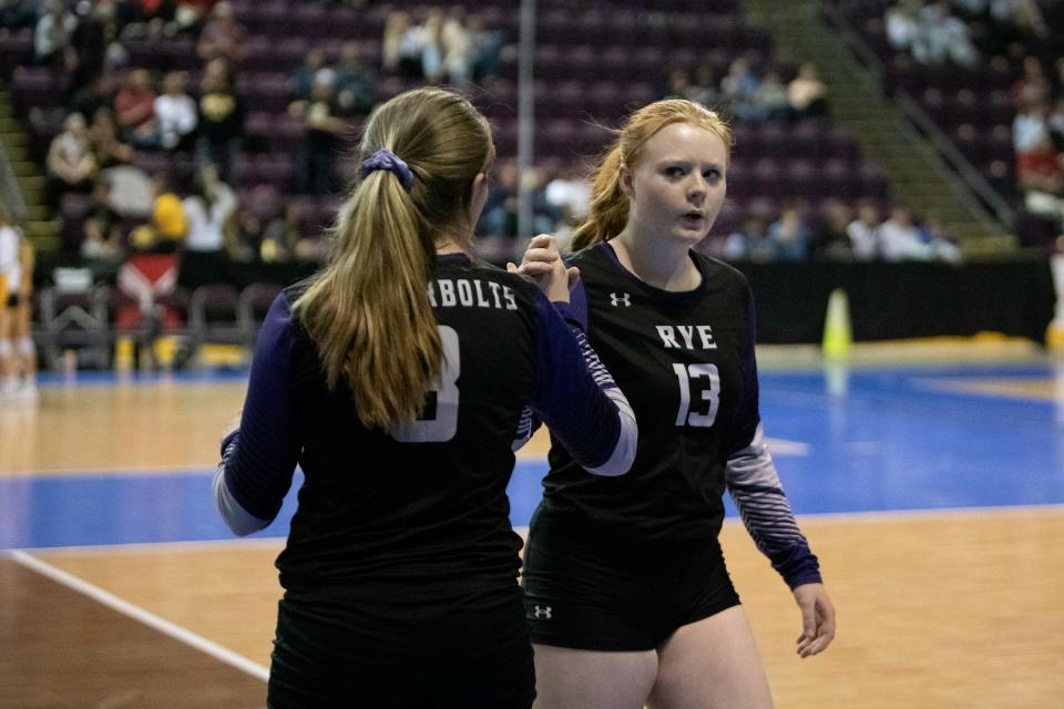 Rye High School's Jaklyn Newitt, left, subs in for teammate Kaitlyn Taylor during the third day matchup with Holyoke at the Class 2A state girls volleyball tournament on Saturday, November 13, 2021.