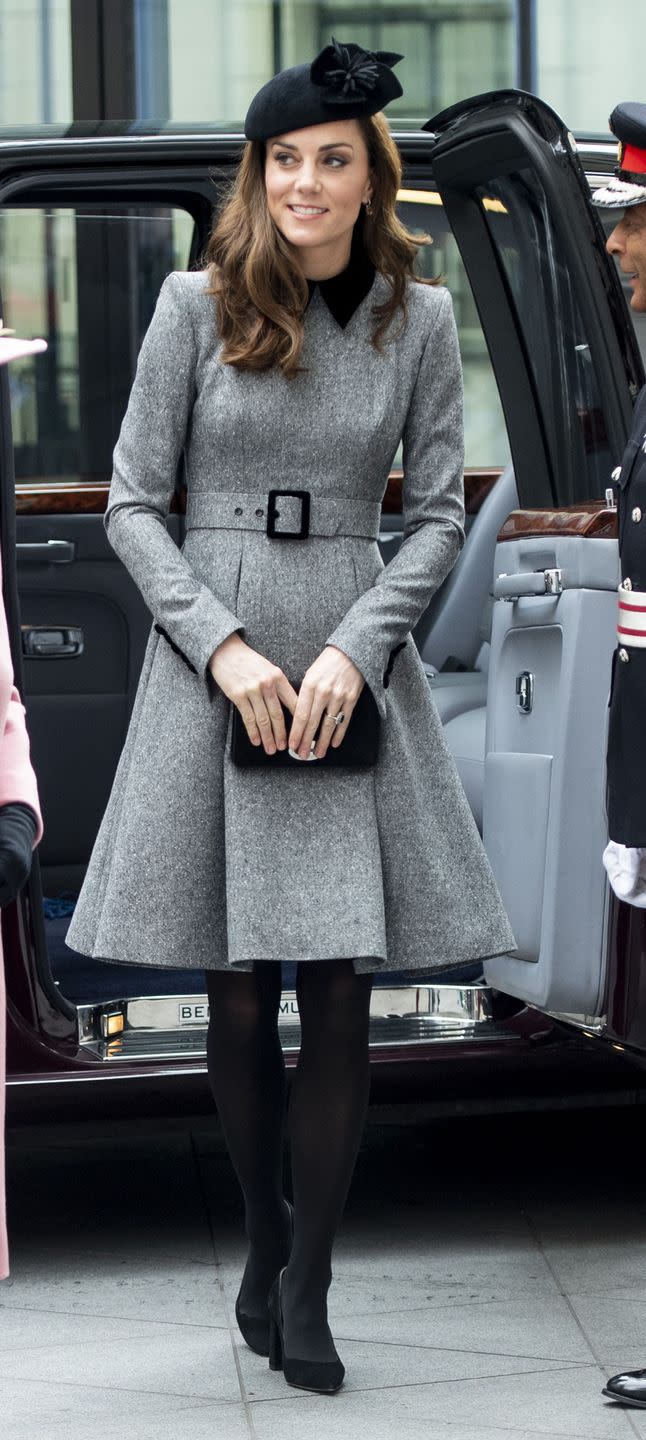 <p>The Duchess of Cambridge arrived at Kings College London wearing a gray Catherine Walker Coat Dress with black trim. She paired the look with black tights and pumps and a Sylvia Fletcher for Lock Hatters hat. She also carried a small black clutch.</p>