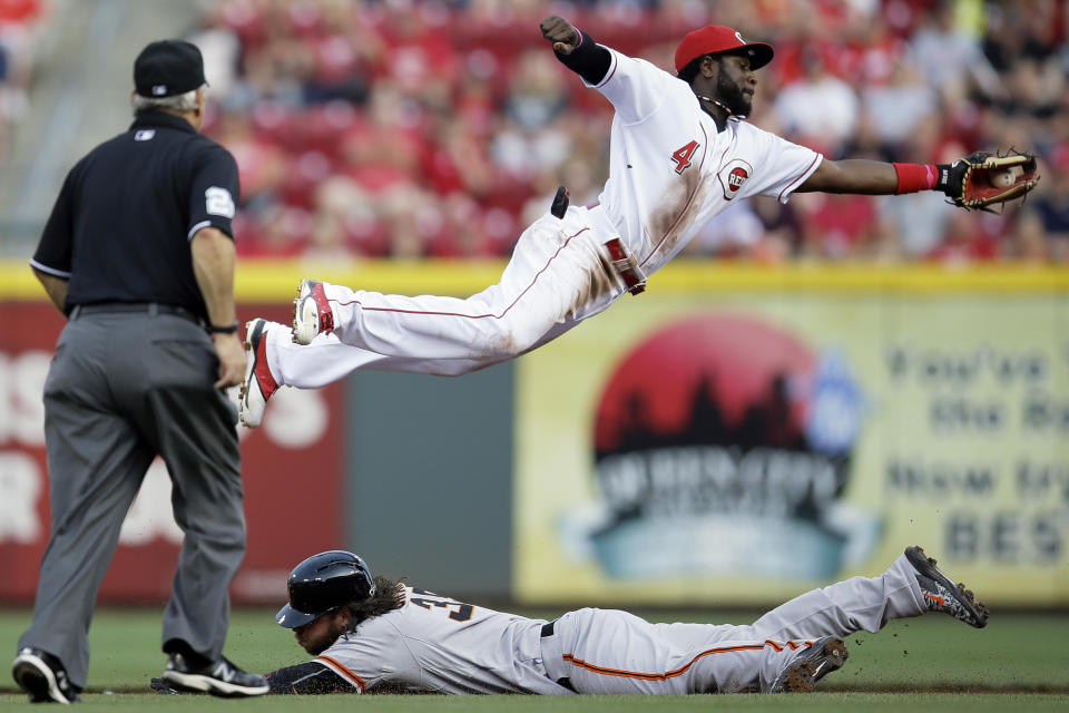 FILE - San Francisco Giants' Brandon Crawford, bottom, steals second base against Cincinnati Reds second baseman Brandon Phillips (4) in the second inning of a baseball game, May 15, 2015, in Cincinnati. Former Major League Baseball star Phillips and current women's pro wrestler Jade Cargill took on professional sports franchise ownership together less than a year ago. The pair led the Texas Smoke to the championship in their first season with Women’s Professional Fastpitch softball on Aug. 13, 2023. (AP Photo/John Minchillo, File)