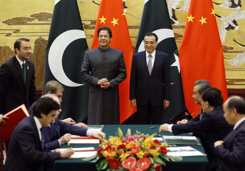 Pakistani Prime Minister Imran Khan, center left, and China's Premier Li Keqiang, center right, attend a signing ceremony at the Great Hall of the People in Beijing Saturday, Nov. 3, 2018. (Jason Lee/Pool Photo via AP)