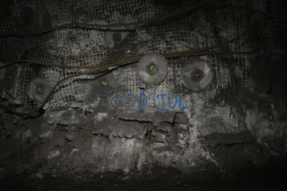 'Merry Christmas' is written in Norwegian on the wall at the bottom of the Gruve 7 coal mine in Adventdalen, Norway, Monday, Jan. 9, 2023. Gruve 7, the last Norwegian mine in one of the fastest warming places on earth, was scheduled to shut down this year and only got a reprieve through 2025 because of the energy crisis driven by the war in Ukraine. (AP Photo/Daniel Cole)