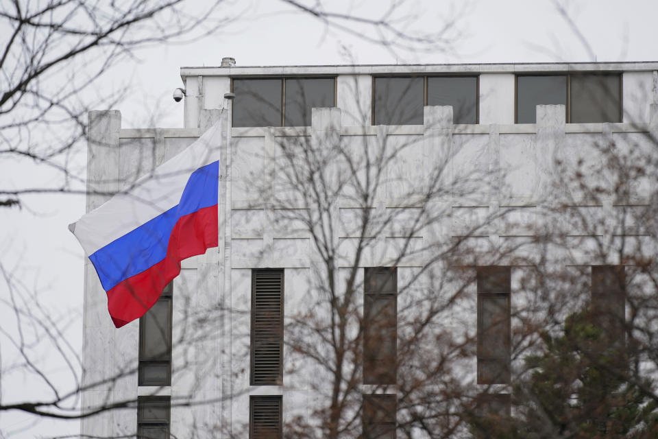 FILE - The Russian flag flies outside the Embassy of Russia in Washington, Feb. 24, 2022. The United States and allies are stepping up sanctions against Russia over its invasion of Ukraine. (AP Photo/Patrick Semansky, File)