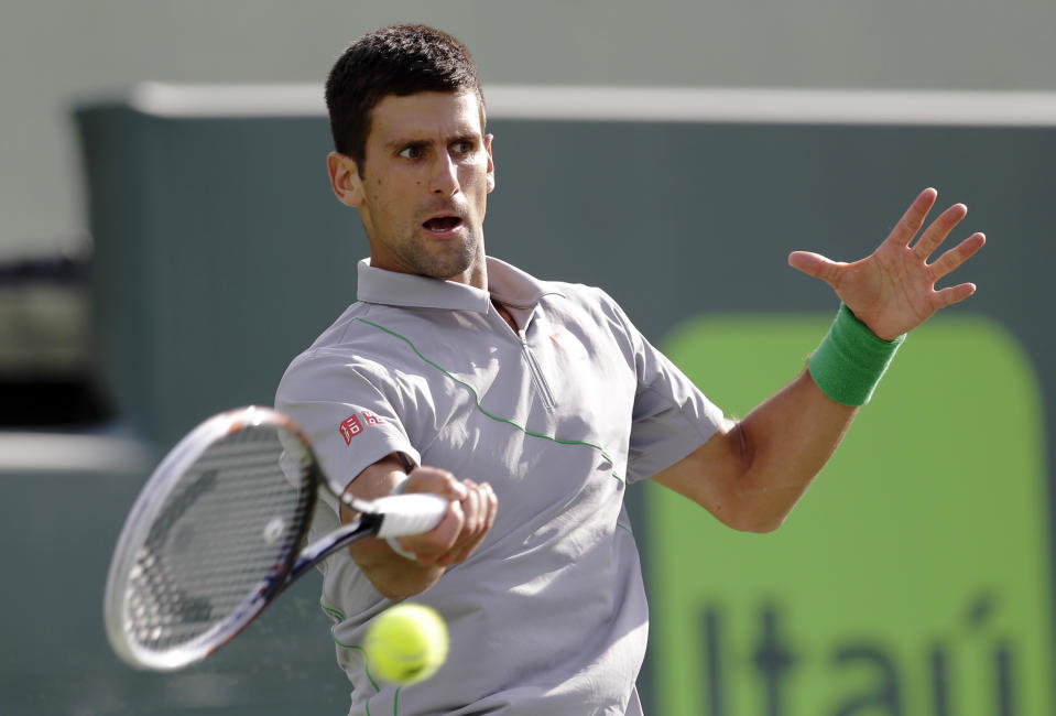 Novak Djokovic, of Serbia, returns to Andy Murray, of Great Britain, at the Sony Open Tennis tournament in Key Biscayne, Fla., Wednesday, March 26, 2014. (AP Photo/Alan Diaz)