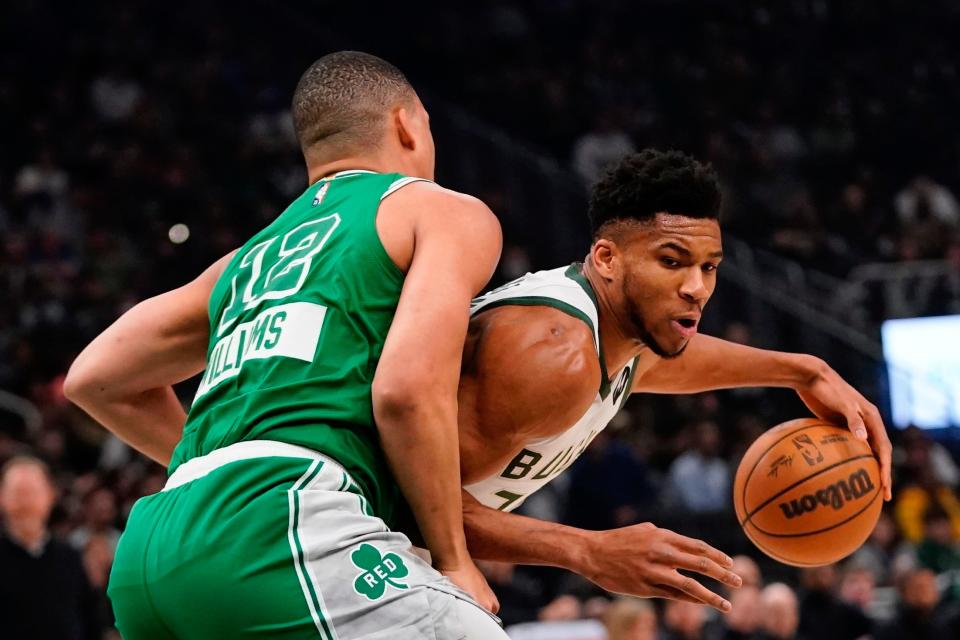 Milwaukee Bucks' Giannis Antetokounmpo tried to get past Boston Celtics' Grant Williams during the first half of an NBA basketball game Thursday, April 7, 2022, in Milwaukee. (AP Photo/Morry Gash)