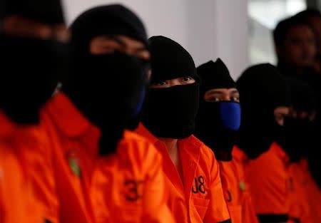 Recently arrested drug trafficking suspects, including foreigners, wait for the start of an illegal narcotics destruction event at police headquarters in Jakarta, Indonesia July 21, 2016. REUTERS/Darren Whiteside/Files