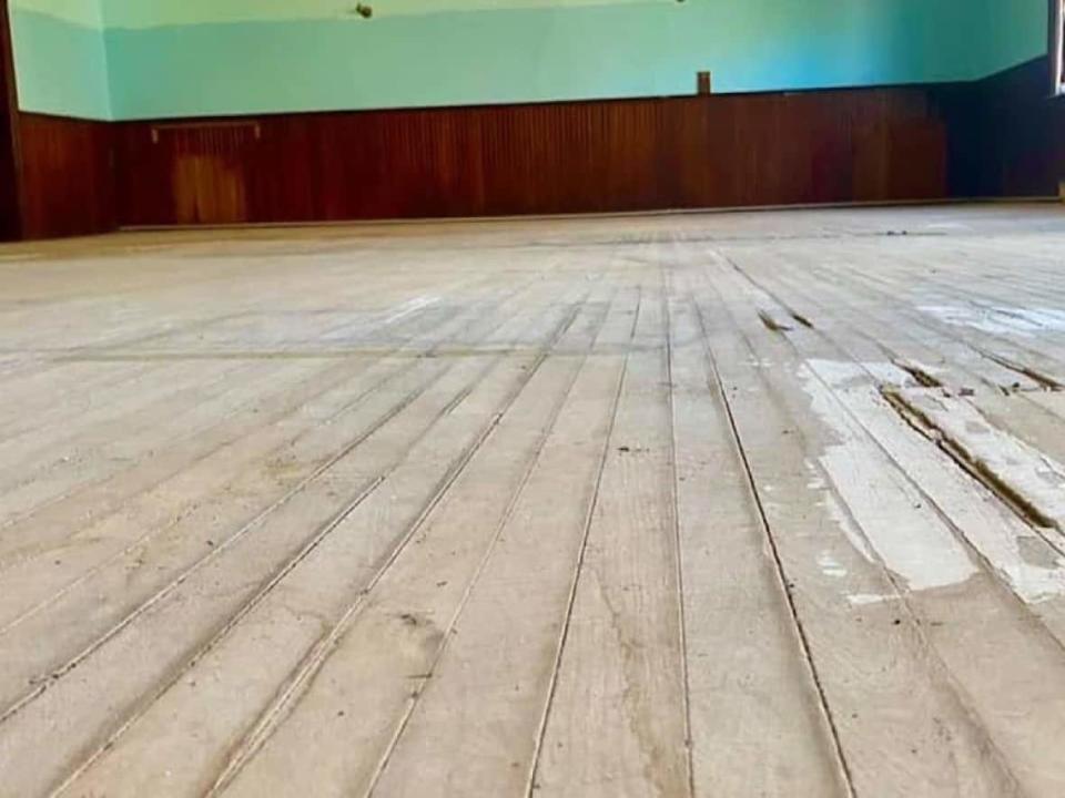 The original gym floor was discovered underneath a carpet. The carpet was removed during cleanup after a small fire in the building. (Canada First Basketball - image credit)